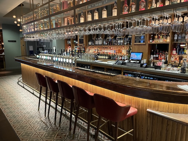 a bar with many glasses and bottles