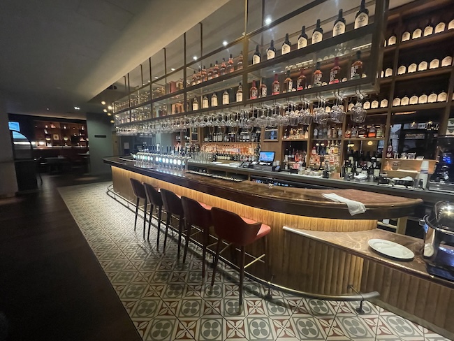 a bar with shelves of liquor and bottles