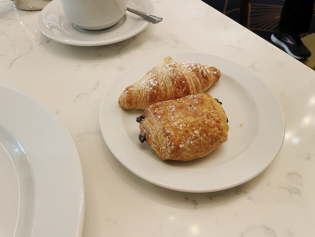 a plate of croissants and a cup of coffee