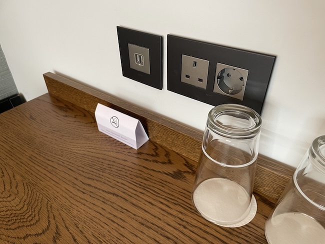 a table with a glass and a sign on it