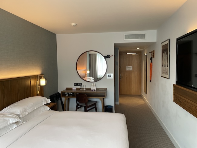a room with a bed and a mirror