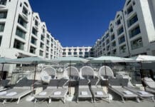 a group of lounge chairs and umbrellas in a hotel