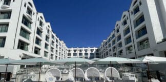 a group of lounge chairs and umbrellas in a hotel
