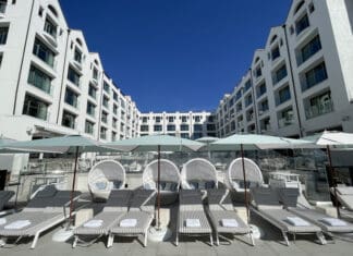 a group of lounge chairs and umbrellas in a hotel