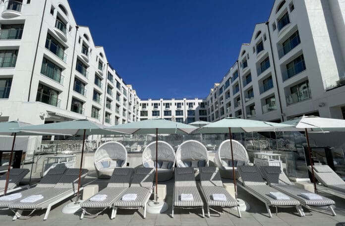 a group of lounge chairs and umbrellas in a hotel