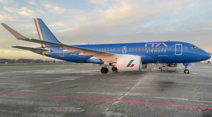 a blue airplane on a runway