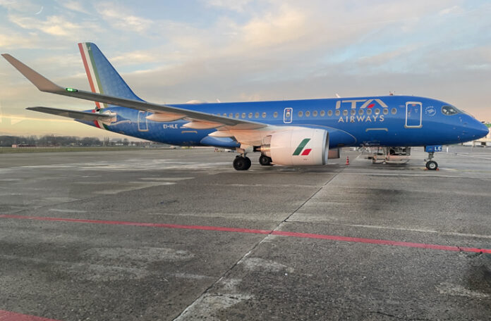 a blue airplane on a runway