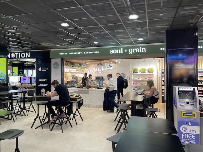 people sitting at tables in a food court