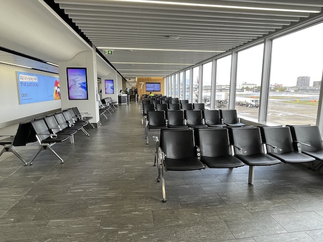 a row of chairs in a room with windows