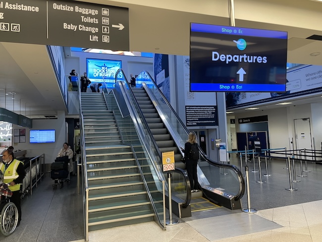 a woman standing on an escalator