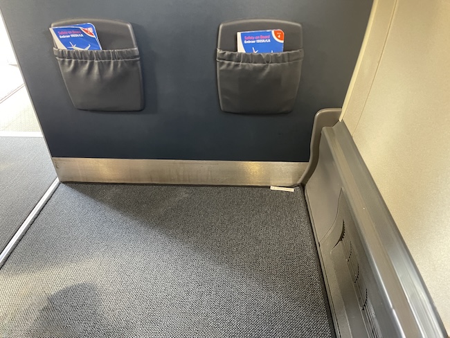 a seat with two pockets on the wall