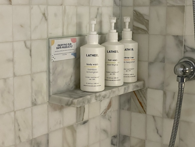 a group of white bottles on a marble shelf