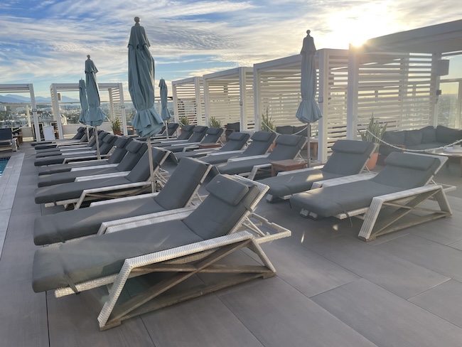 a group of lounge chairs on a rooftop