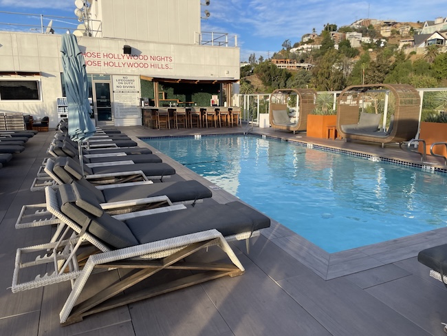 a pool with lounge chairs and a bar