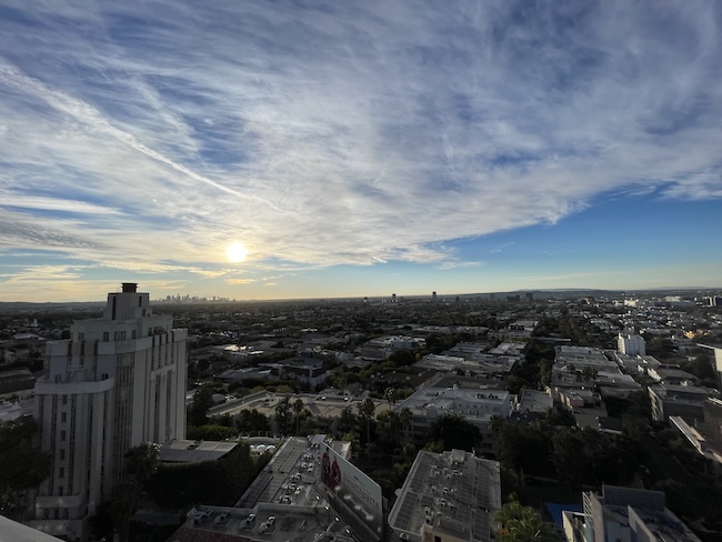 a city with many buildings and a blue sky