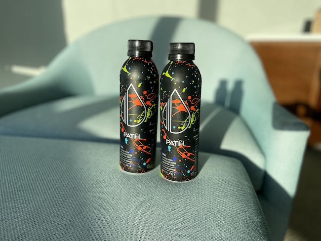 two bottles of liquid on a chair