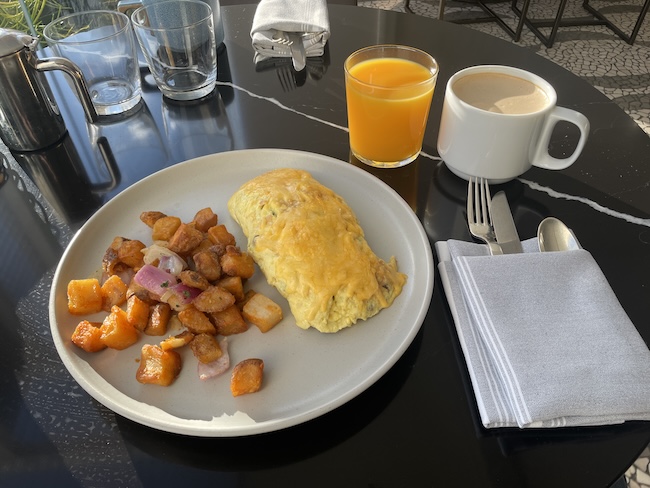 a plate of food and a drink on a table