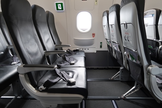 seats in an airplane with a seat belt