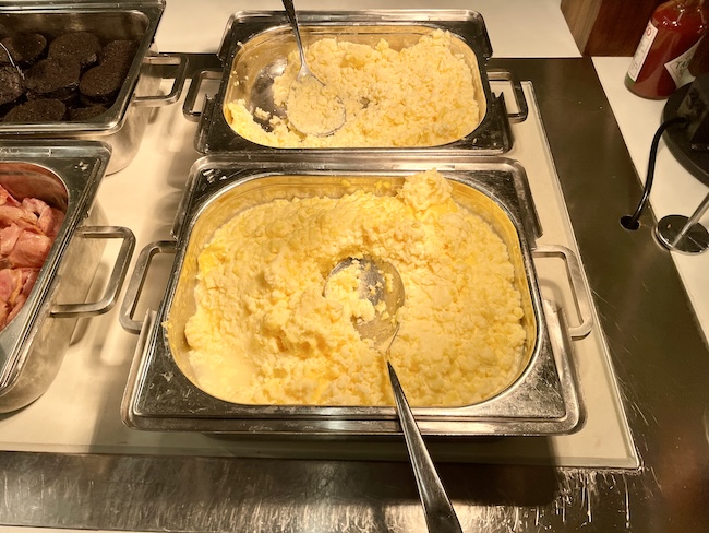 food in a container with spoons