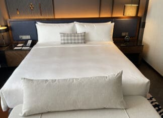 a bed with a white sheet and a pillow