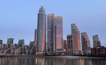 Amex adds 358 hotels to Fine Hotels + Resorts and The Hotel Collection a city skyline with many tall buildings and a body of water