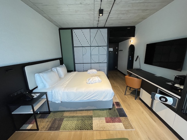 a room with a bed and a television
