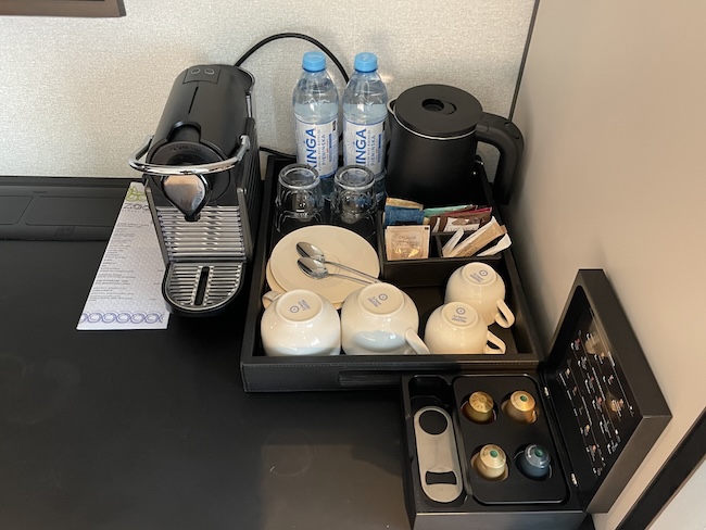 a coffee machine and tea cups
