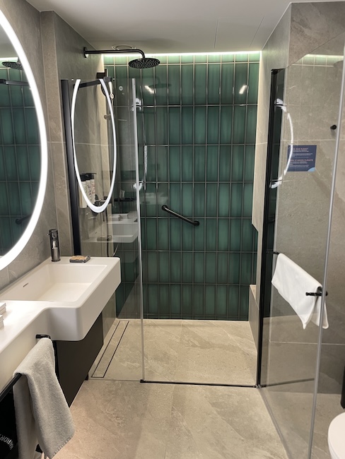a bathroom with a shower and sink