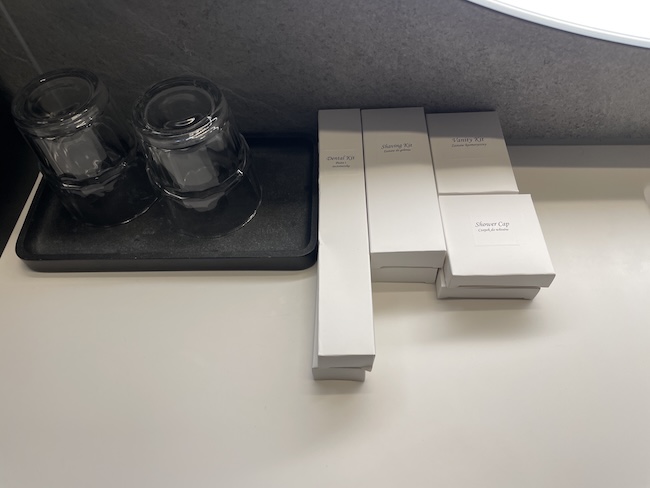 a group of white boxes and jars on a black tray