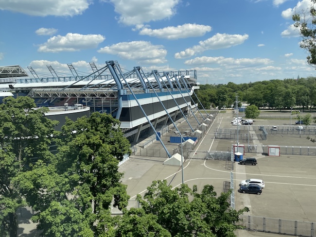 a stadium with trees and blue sky