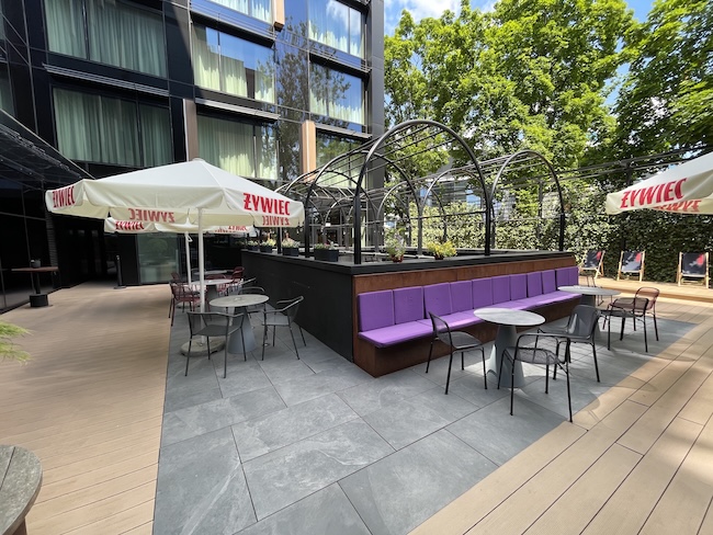 a patio area with tables and umbrellas
