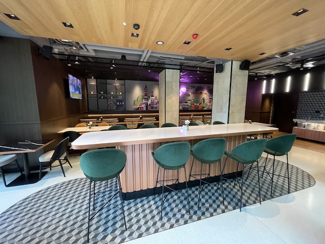 a room with a bar and chairs