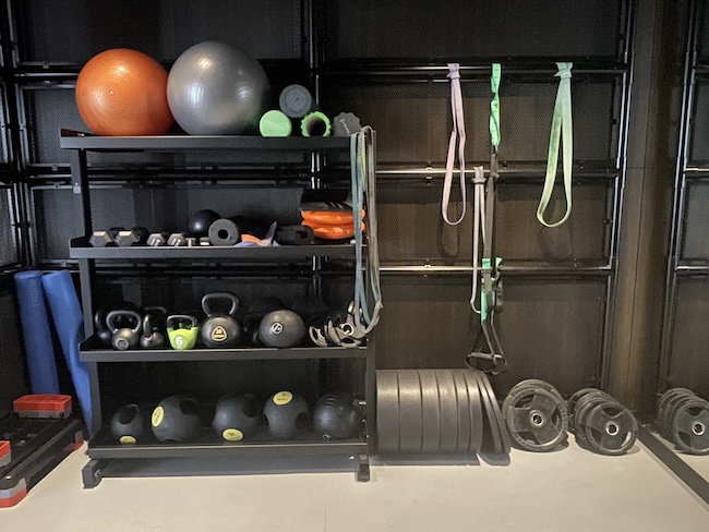 a shelf with exercise equipment and weights