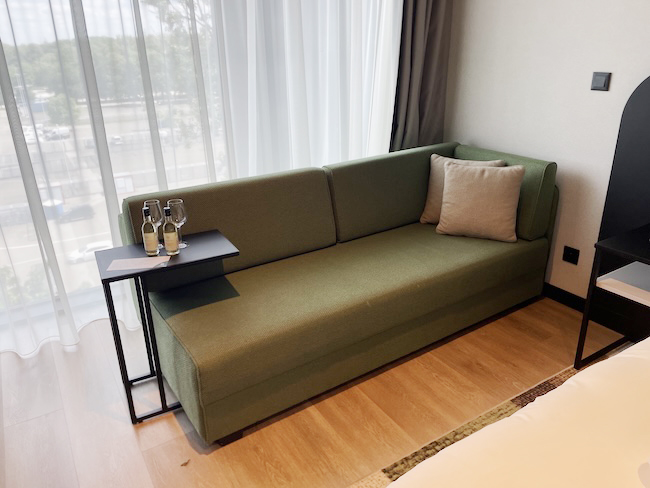 a green couch with a table and pillows
