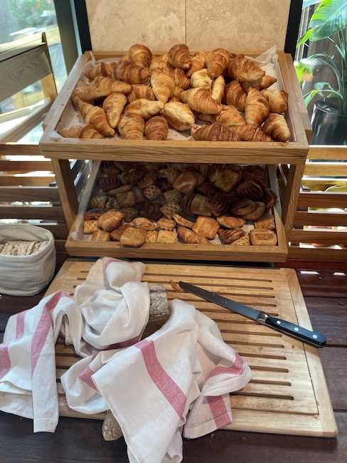 a tray of pastries and bread on a cutting board