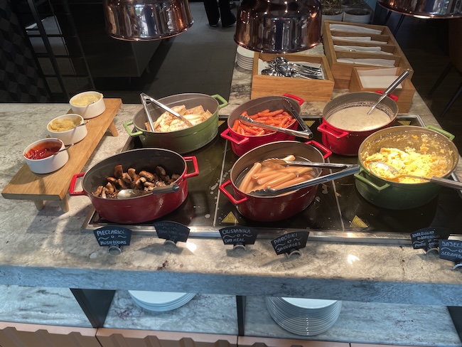 a buffet table with food in pots