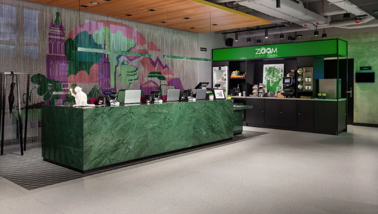 a green counter with a person sitting at it