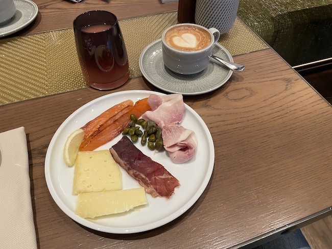 a plate of food and a cup of coffee on a table