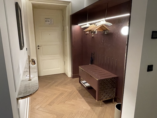 a hallway with a coat rack and a mirror
