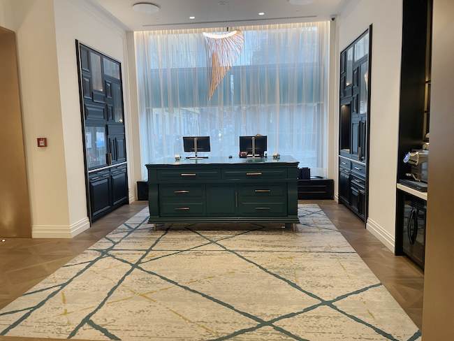 a room with a desk and a rug