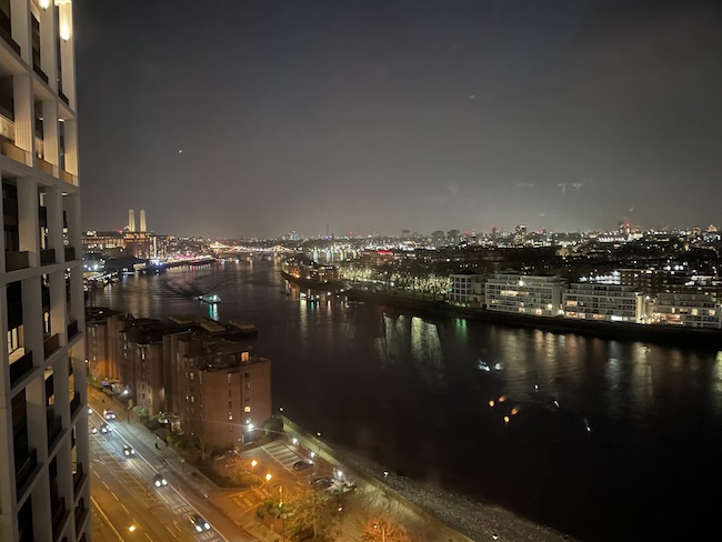 a city at night with a river and buildings