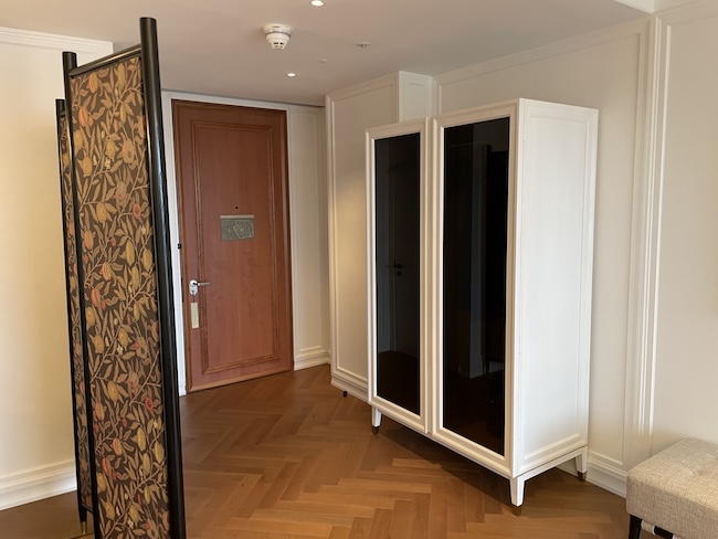 a room with a white cabinet and a brown door