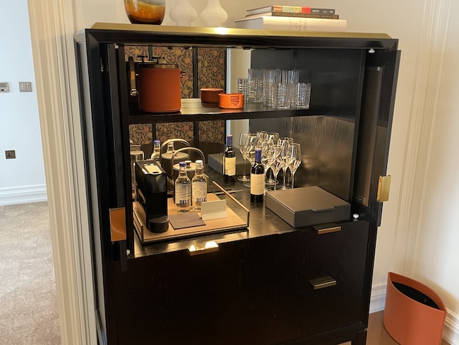 a bar with wine glasses and bottles