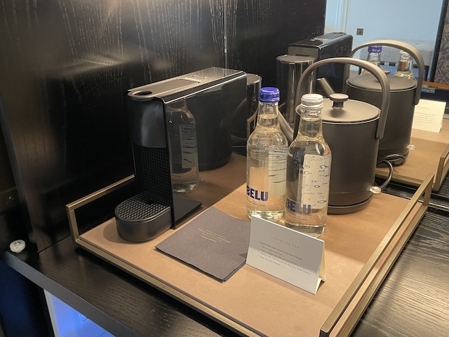 a coffee machine and bottles on a table