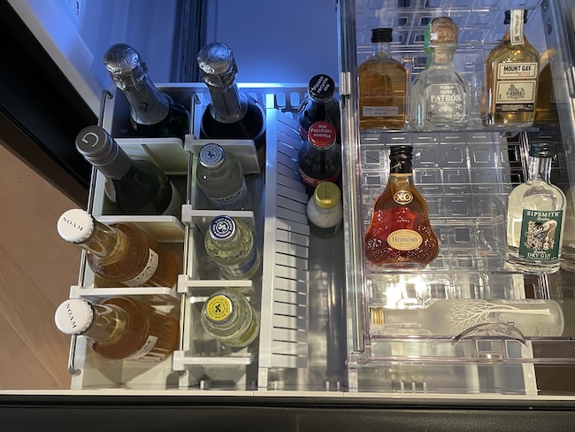a fridge with bottles of alcohol
