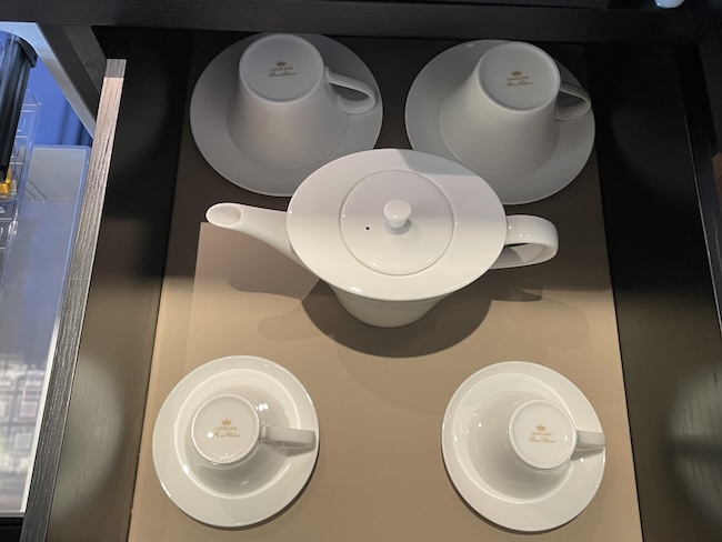 a tea set on a shelf