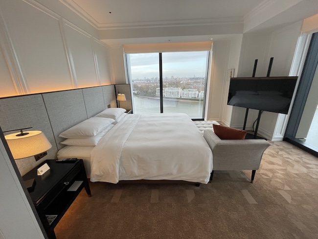 a bedroom with a large window and a large bed