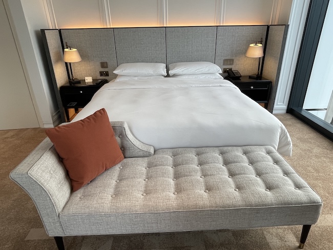 a bed with a couch and a bed with a headboard