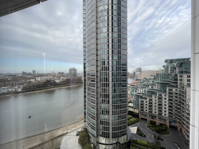 a tall building next to a river