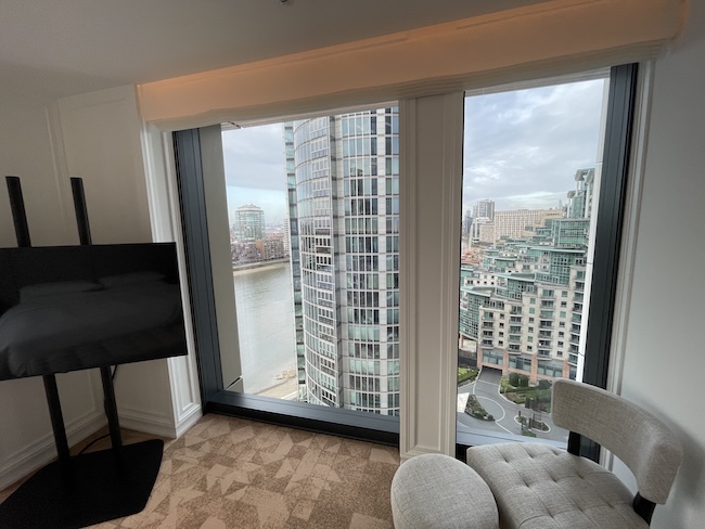 a room with a large window overlooking a city